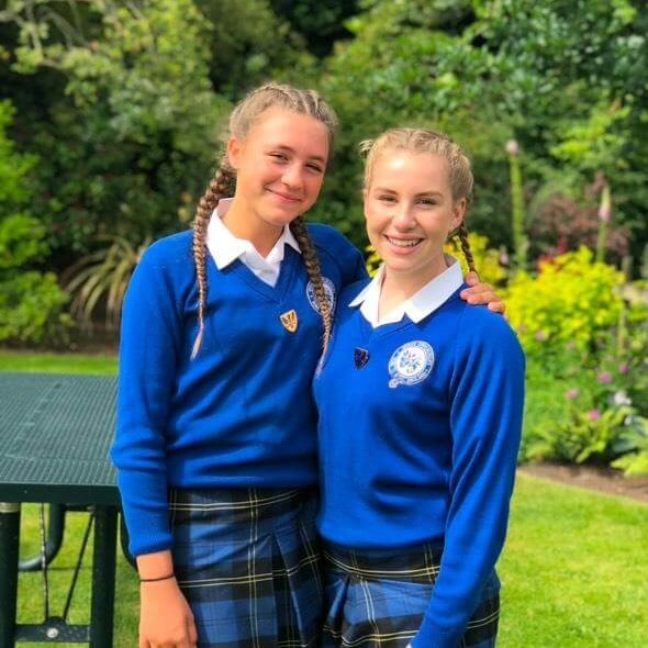 Jemima in QE Faculty's blue uniform.